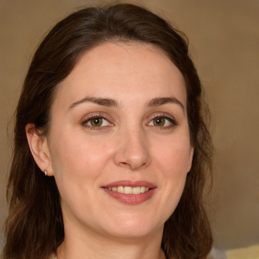 Joyful white young-adult female with long  brown hair and green eyes