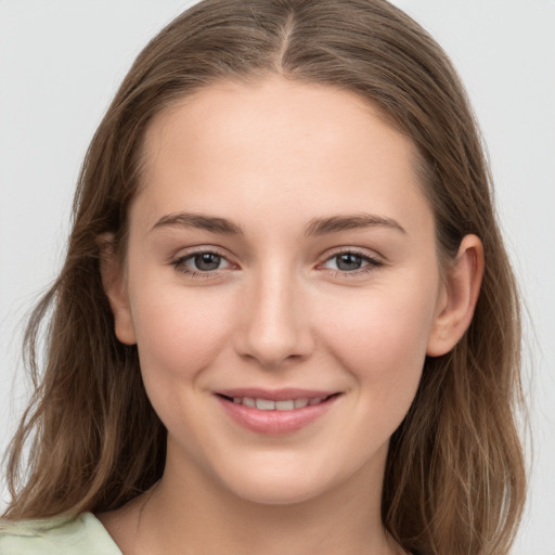 Joyful white young-adult female with long  brown hair and grey eyes