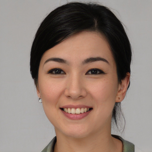Joyful white young-adult female with medium  black hair and brown eyes