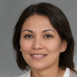 Joyful white adult female with medium  brown hair and brown eyes