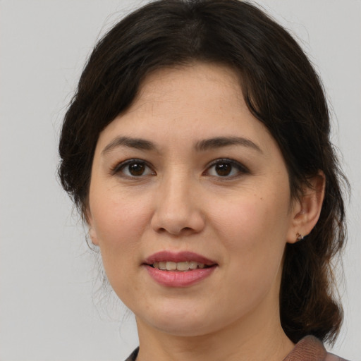 Joyful white young-adult female with medium  brown hair and brown eyes