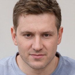 Joyful white adult male with short  brown hair and grey eyes