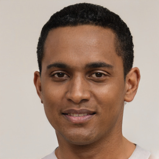 Joyful black young-adult male with short  black hair and brown eyes