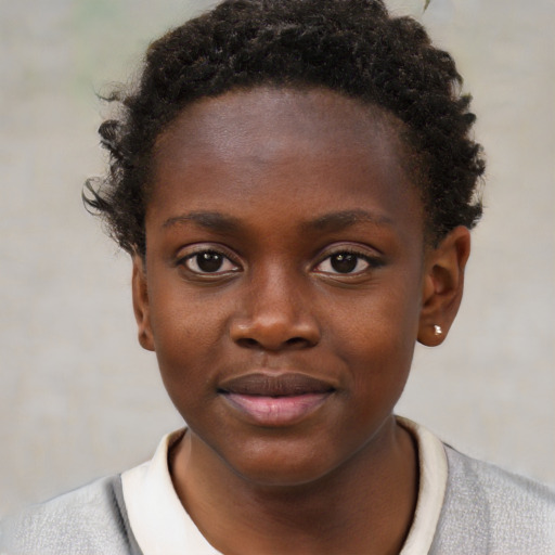 Joyful black child female with short  brown hair and brown eyes