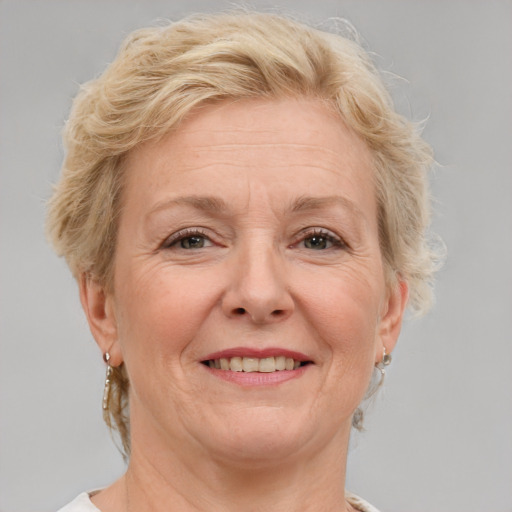 Joyful white middle-aged female with medium  brown hair and blue eyes