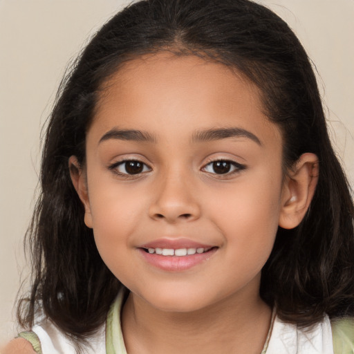 Joyful white child female with long  brown hair and brown eyes