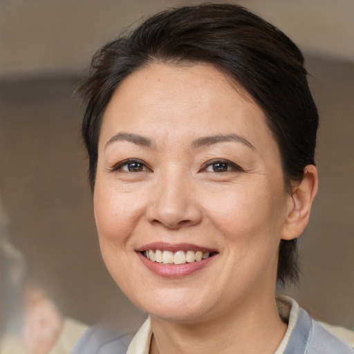 Joyful white adult female with medium  brown hair and brown eyes