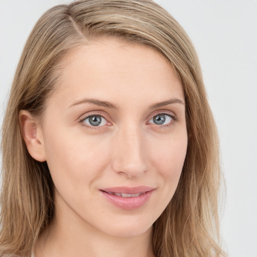 Joyful white young-adult female with long  brown hair and blue eyes