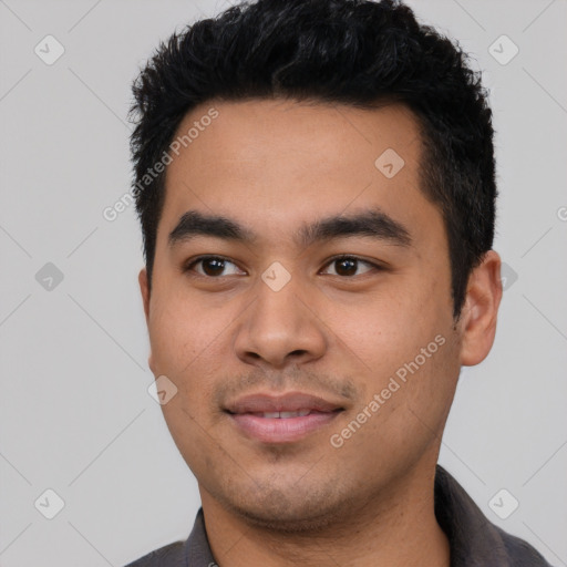 Joyful latino young-adult male with short  black hair and brown eyes