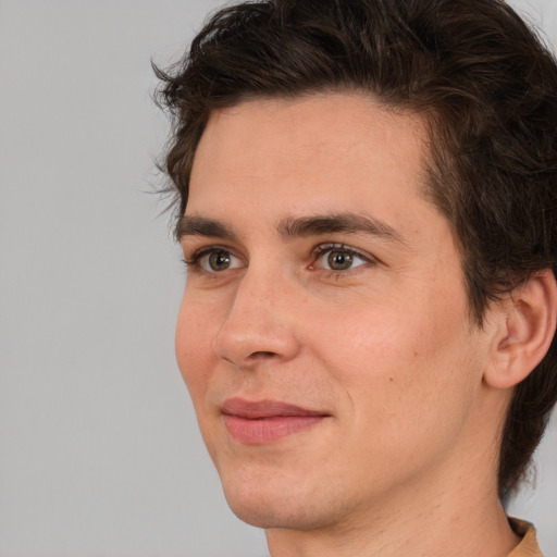 Joyful white young-adult male with medium  brown hair and brown eyes