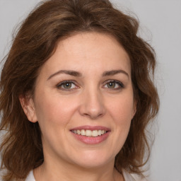 Joyful white young-adult female with medium  brown hair and green eyes