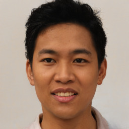 Joyful asian young-adult male with short  black hair and brown eyes