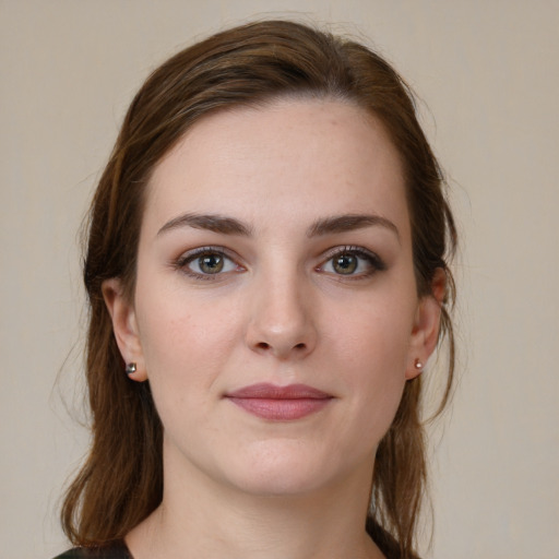 Joyful white young-adult female with medium  brown hair and grey eyes