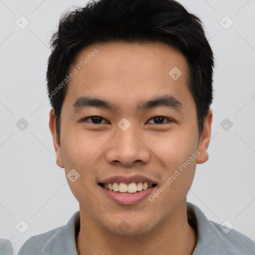 Joyful asian young-adult male with short  black hair and brown eyes