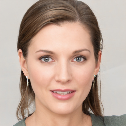 Joyful white young-adult female with medium  brown hair and grey eyes