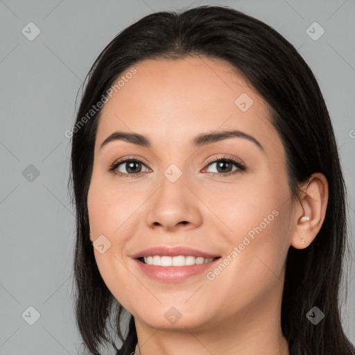 Joyful white young-adult female with long  black hair and brown eyes