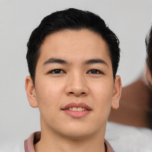 Joyful asian young-adult male with short  brown hair and brown eyes