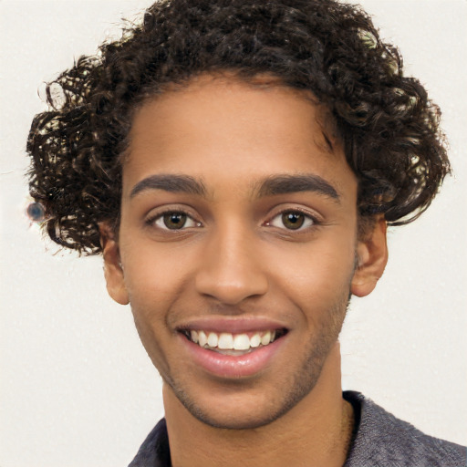 Joyful black young-adult male with short  brown hair and brown eyes