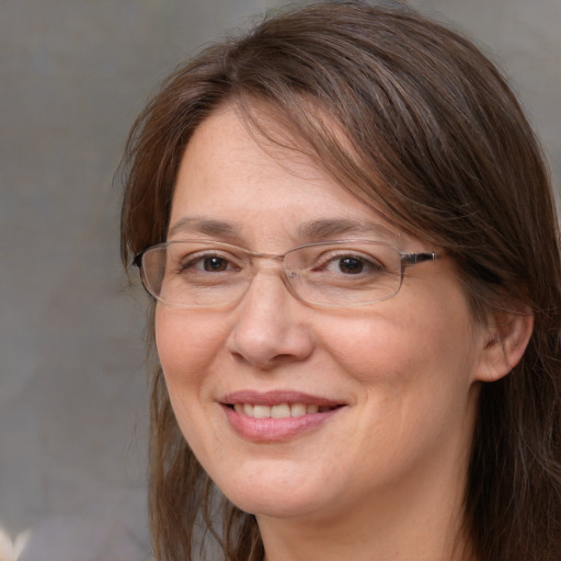 Joyful white adult female with medium  brown hair and brown eyes