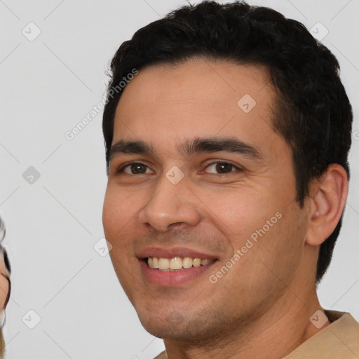 Joyful white young-adult male with short  black hair and brown eyes