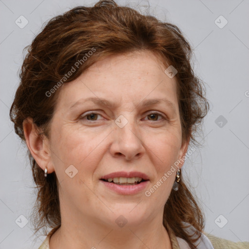 Joyful white adult female with medium  brown hair and blue eyes