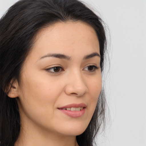 Joyful asian young-adult female with long  brown hair and brown eyes