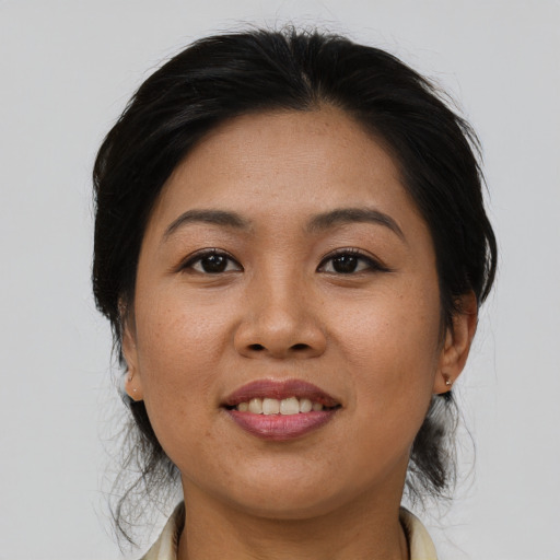 Joyful asian adult female with medium  brown hair and brown eyes