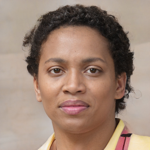 Joyful black young-adult female with short  brown hair and brown eyes