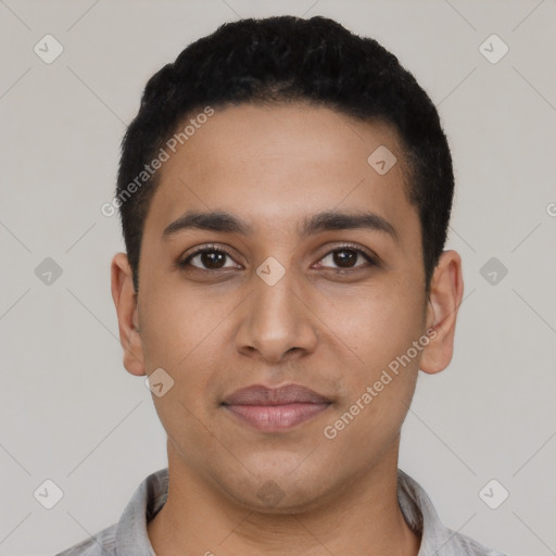 Joyful latino young-adult male with short  black hair and brown eyes