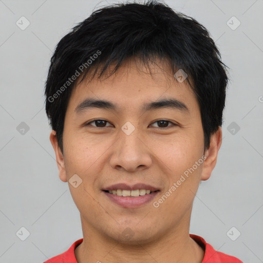 Joyful asian young-adult male with short  black hair and brown eyes