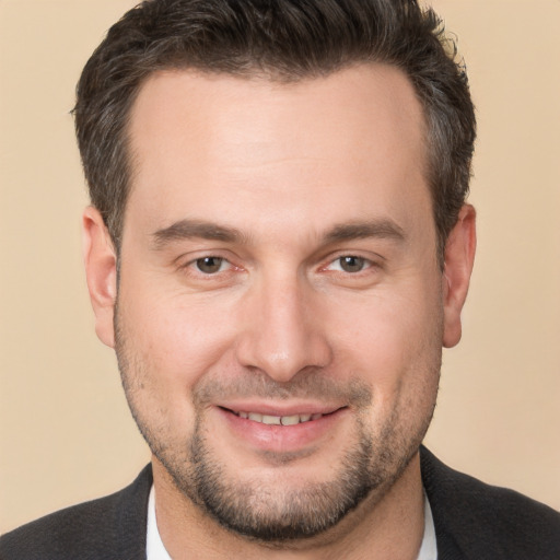 Joyful white adult male with short  brown hair and brown eyes