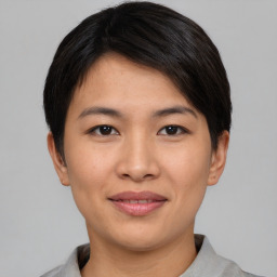 Joyful asian young-adult female with short  black hair and brown eyes