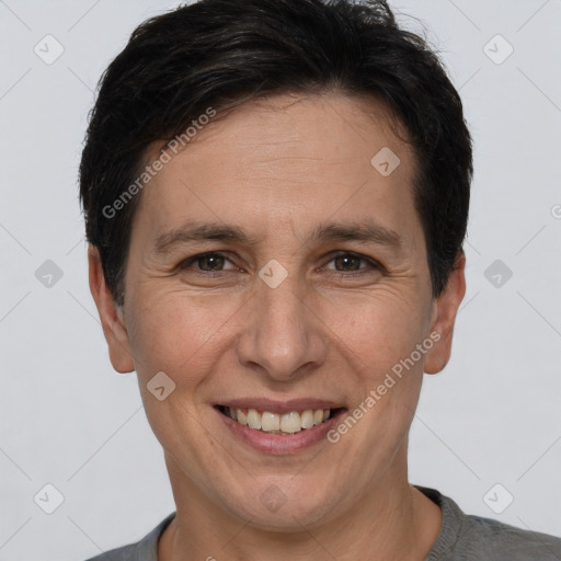 Joyful white adult male with short  brown hair and brown eyes