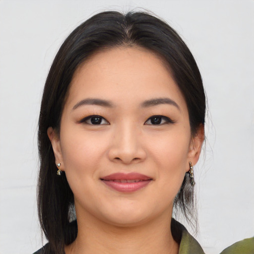 Joyful asian young-adult female with medium  black hair and brown eyes