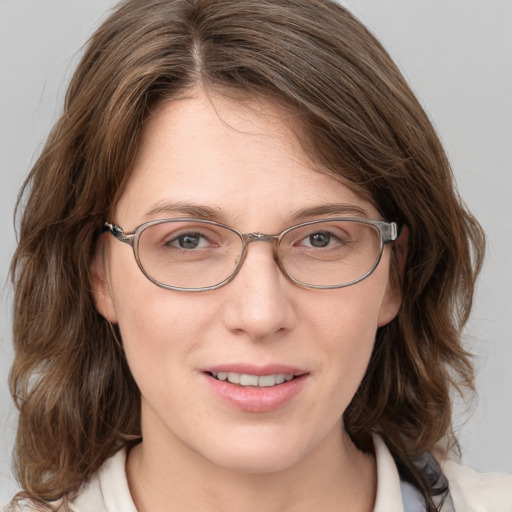 Joyful white adult female with medium  brown hair and blue eyes