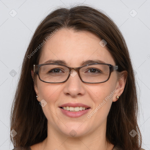 Joyful white adult female with long  brown hair and grey eyes