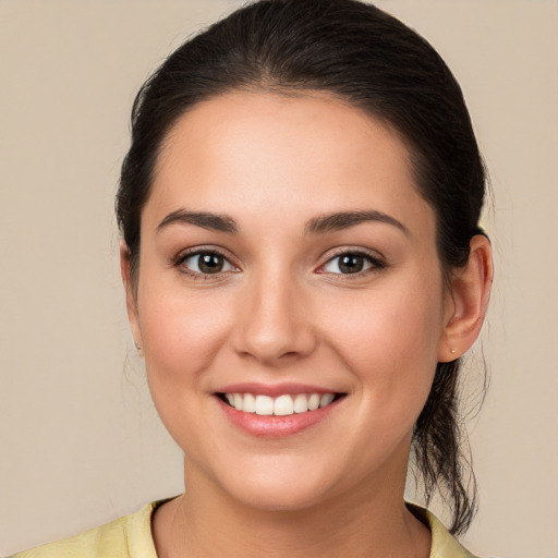 Joyful white young-adult female with medium  brown hair and brown eyes