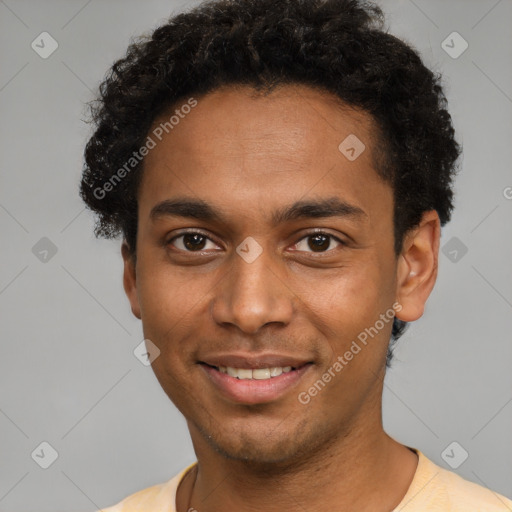 Joyful black young-adult male with short  brown hair and brown eyes