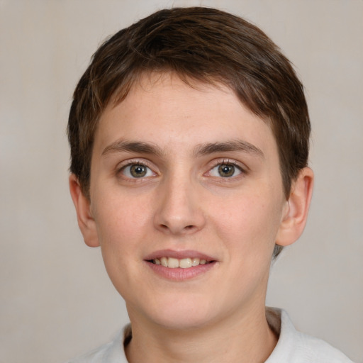 Joyful white young-adult female with short  brown hair and grey eyes