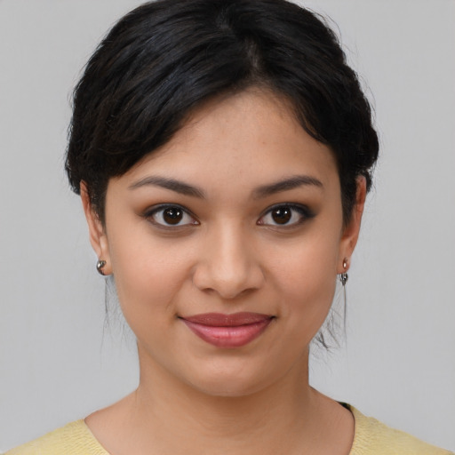Joyful latino young-adult female with medium  brown hair and brown eyes