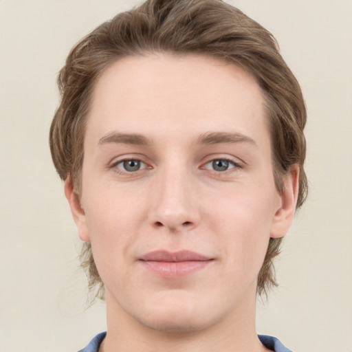 Joyful white young-adult male with medium  brown hair and grey eyes