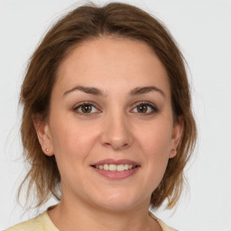 Joyful white young-adult female with medium  brown hair and grey eyes