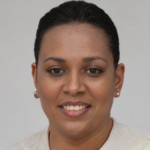 Joyful latino young-adult female with short  black hair and brown eyes