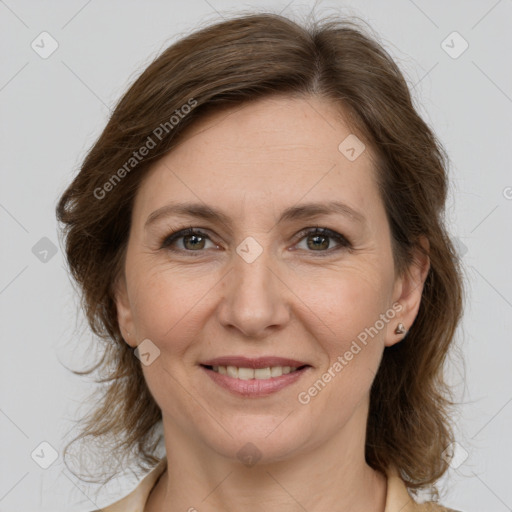 Joyful white adult female with medium  brown hair and grey eyes