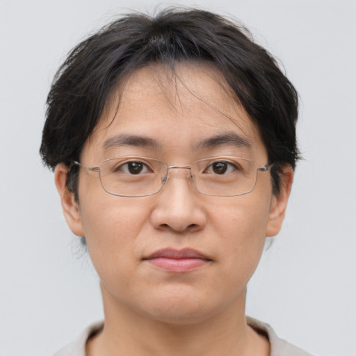 Joyful asian adult male with short  brown hair and brown eyes