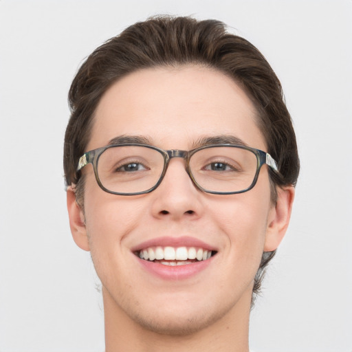 Joyful white young-adult male with short  brown hair and green eyes