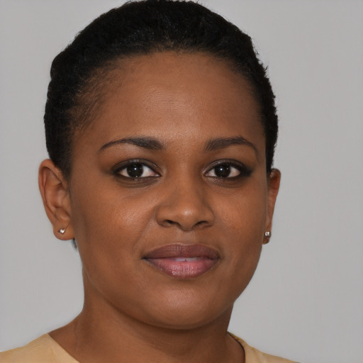 Joyful black young-adult female with short  brown hair and brown eyes