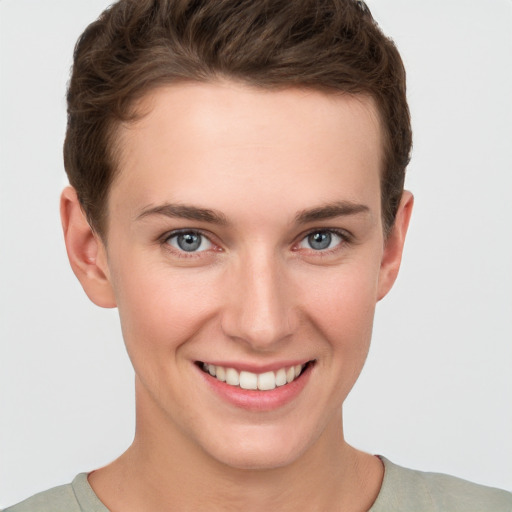 Joyful white young-adult female with short  brown hair and grey eyes