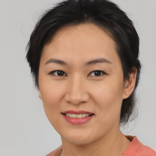 Joyful asian young-adult female with medium  brown hair and brown eyes