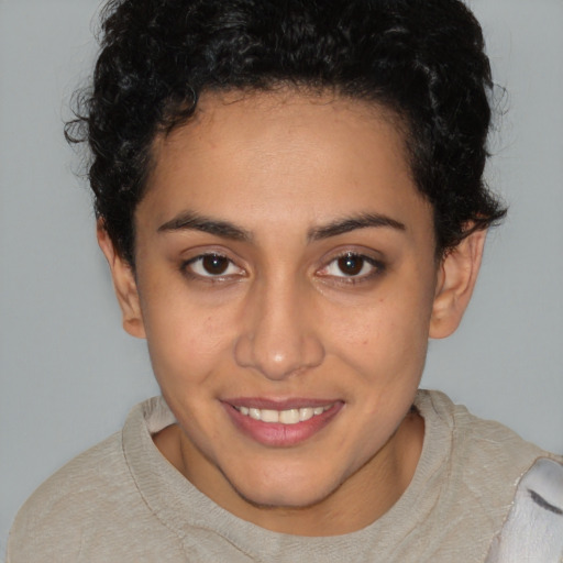 Joyful latino young-adult female with short  brown hair and brown eyes